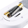 Close-up of the battery compartment of a carbon monoxide alarm with two installed AA batteries and visible safety warnings printed on the batteries and device label.