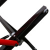 A detailed view of a metal scissor‑lift mechanism with intersecting red and black support arms connected by pivot bolts and rollers.