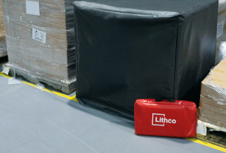 Ultrafire Lithium Ion Fire Containment black fireproof bag with red Lithco case on warehouse floor next to pallets